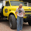 Load image into Gallery viewer, Person wearing a 'Off-Road' t-shirt standing next to a yellow Chevrolet truck.
